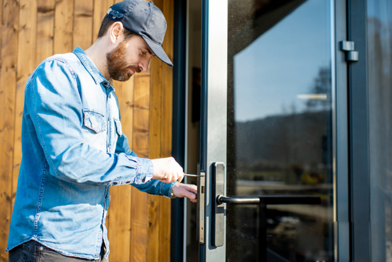 Locksmith working on a commercial door lock