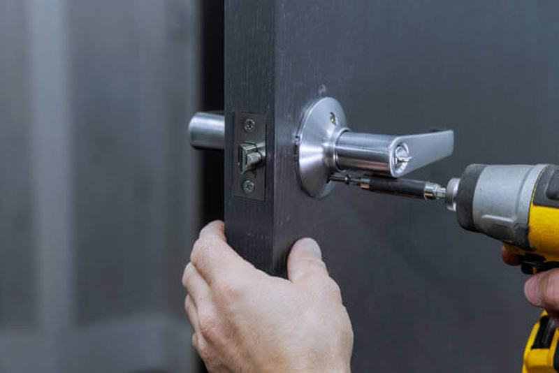 Locksmith drilling a door lock